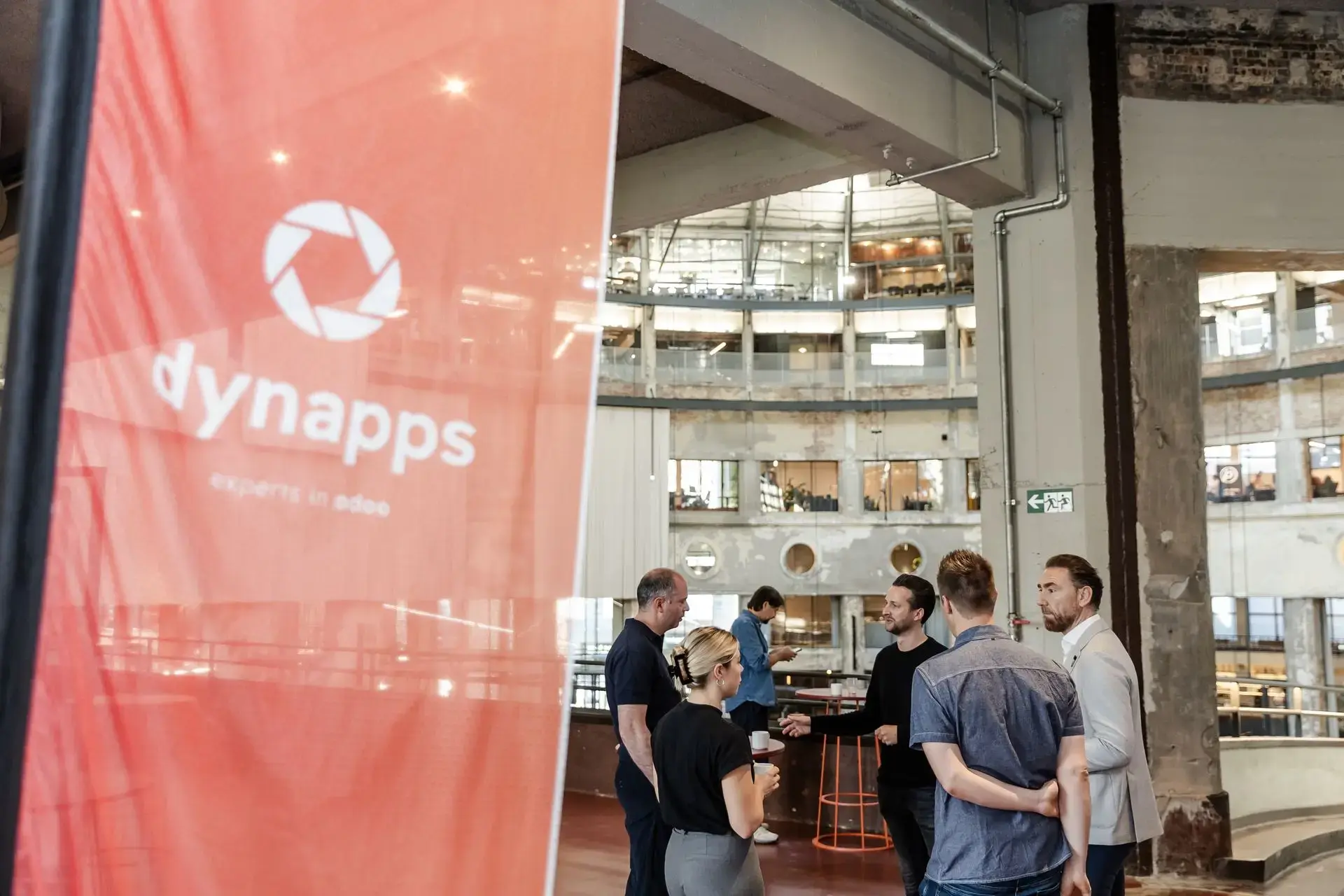 A Dynapps breakfast session in Belgium: small group, coffee on the table, Odoo demo on screen.